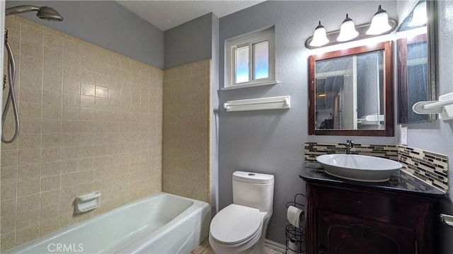 bathroom with decorative backsplash, toilet, bathtub / shower combination, and vanity