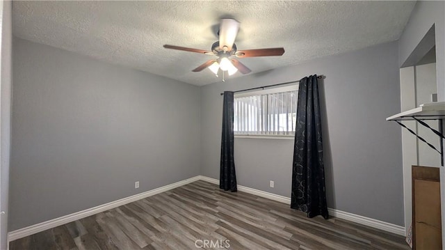 unfurnished room featuring wood finished floors, baseboards, and ceiling fan