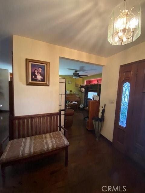 entryway featuring ceiling fan with notable chandelier