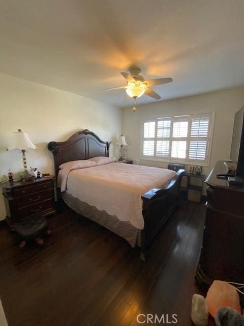 bedroom featuring a ceiling fan and dark wood-style flooring