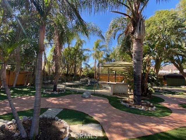 view of community featuring a patio area and fence