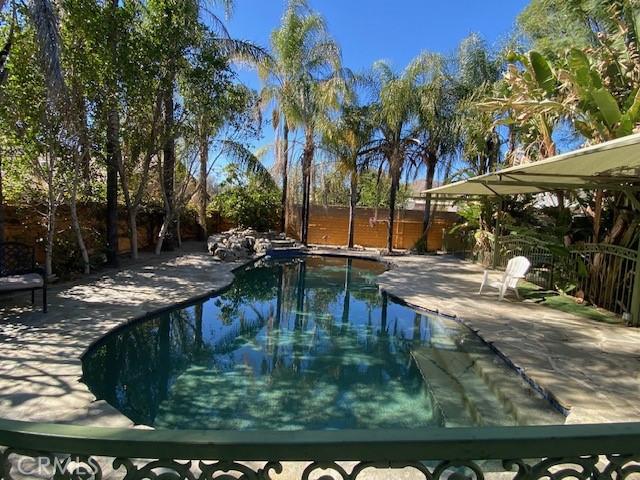 view of swimming pool with a patio, a fenced backyard, and a fenced in pool