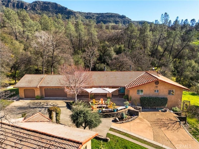 drone / aerial view with a mountain view and a wooded view