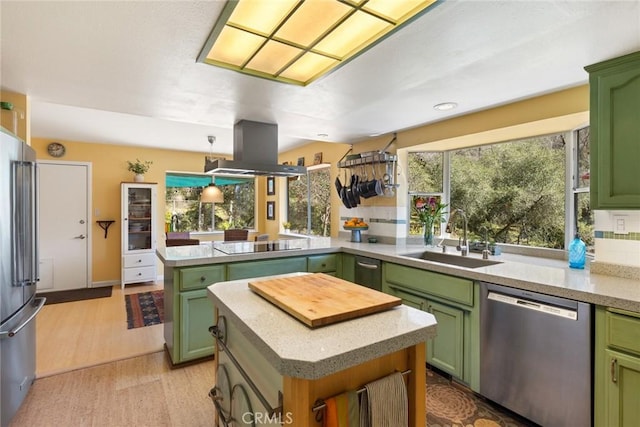 kitchen with appliances with stainless steel finishes and green cabinetry