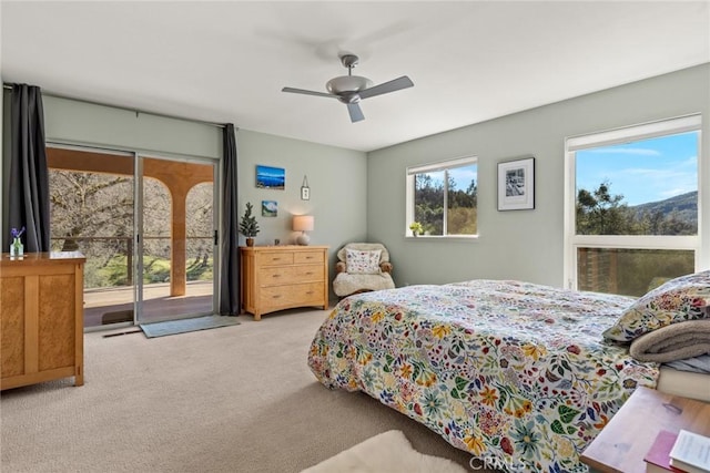 carpeted bedroom with visible vents, a ceiling fan, and access to outside