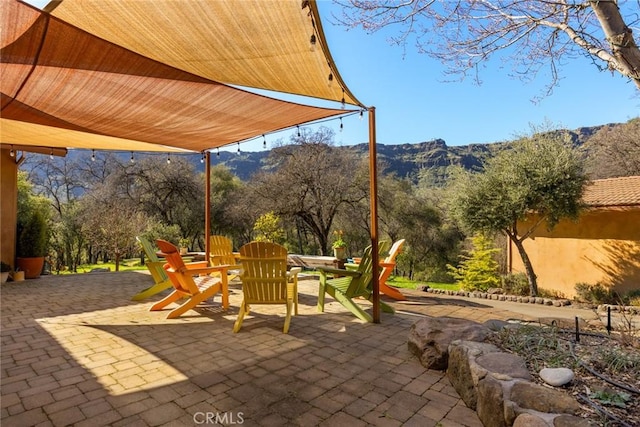 view of patio / terrace with outdoor dining space and a mountain view