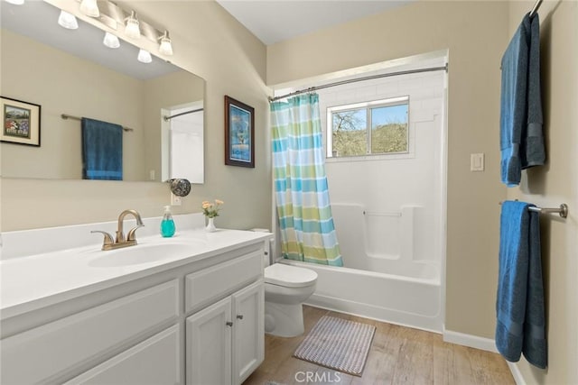 bathroom with toilet, wood finished floors, shower / bath combination with curtain, baseboards, and vanity