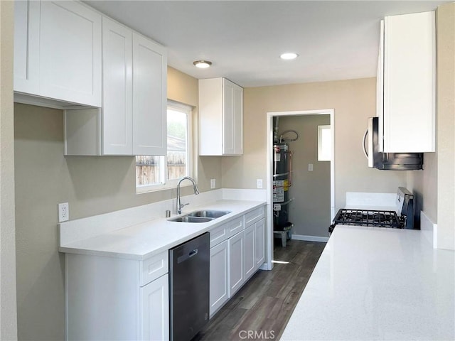 kitchen featuring range with gas cooktop, light countertops, dishwashing machine, white cabinets, and a sink