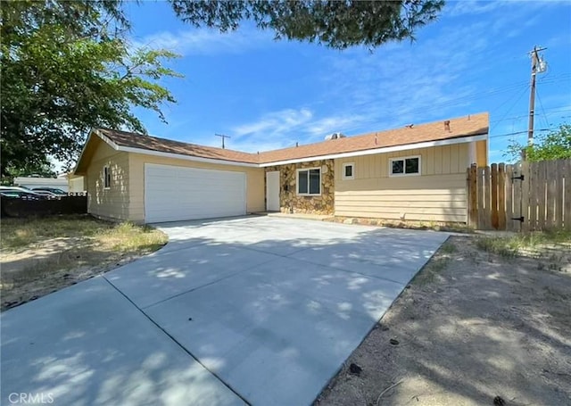 45541 Sancroft Ave, Lancaster, CA 93535 - single story home with fence, an attached garage, driveway, and stone siding