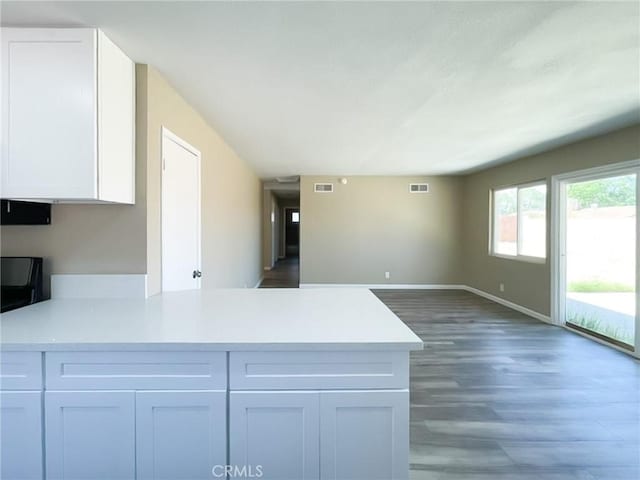 45541 Sancroft Ave, Lancaster, CA 93535 - kitchen featuring a peninsula, light countertops, white cabinets, and open floor plan