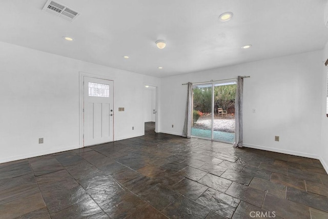 interior space with baseboards, visible vents, and stone finish flooring