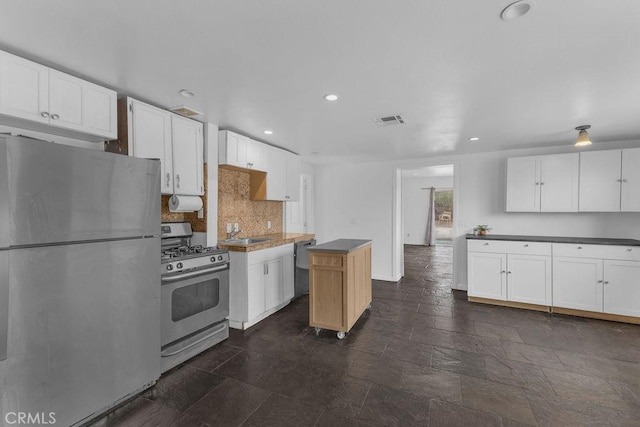 kitchen with visible vents, white cabinets, appliances with stainless steel finishes, and a sink