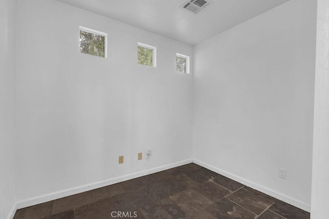 empty room with visible vents and baseboards