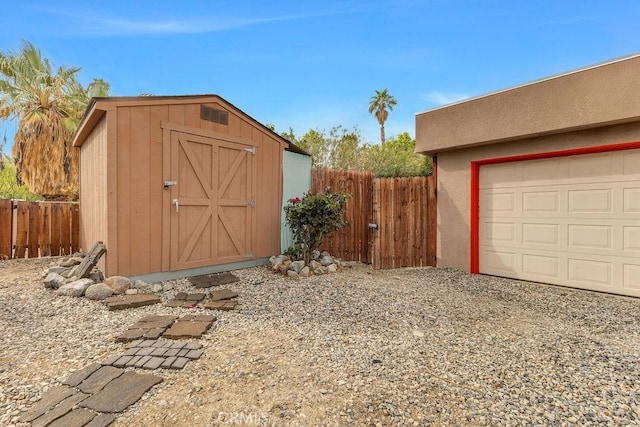 view of shed featuring a garage and fence