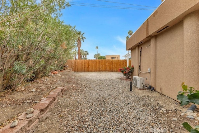 view of yard featuring a patio area, ac unit, and fence private yard