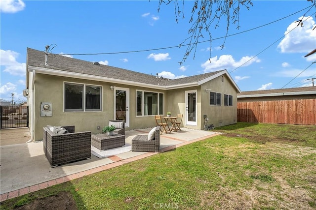 back of house with a patio, fence, a yard, stucco siding, and outdoor lounge area