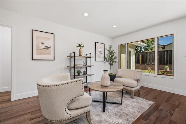 living area with recessed lighting, wood finished floors, and baseboards