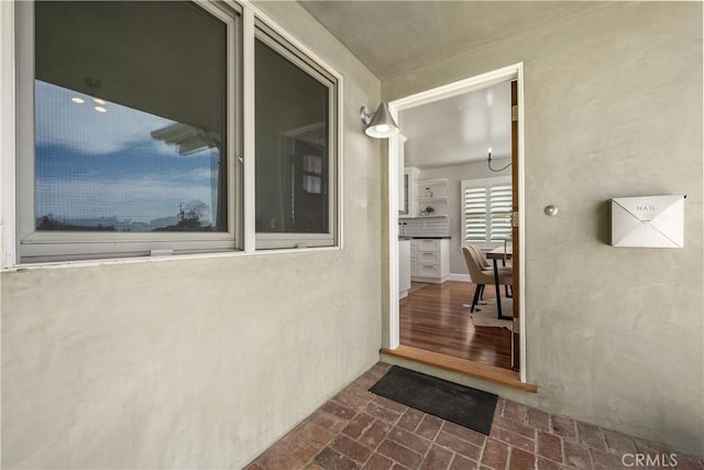 entrance to property featuring stucco siding