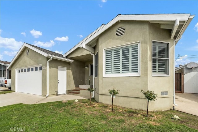 single story home featuring stucco siding, driveway, a front lawn, and a garage