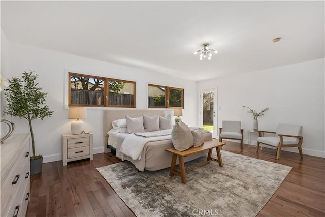 bedroom featuring baseboards and dark wood-type flooring