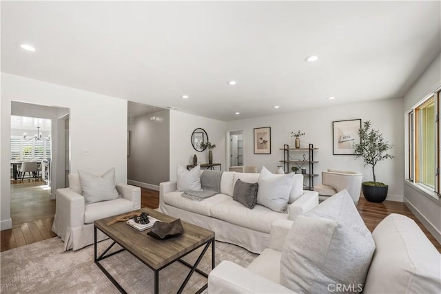 living area featuring a chandelier, recessed lighting, and light wood-type flooring