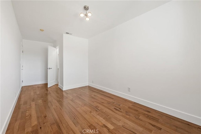 unfurnished bedroom featuring visible vents, baseboards, and light wood-style floors