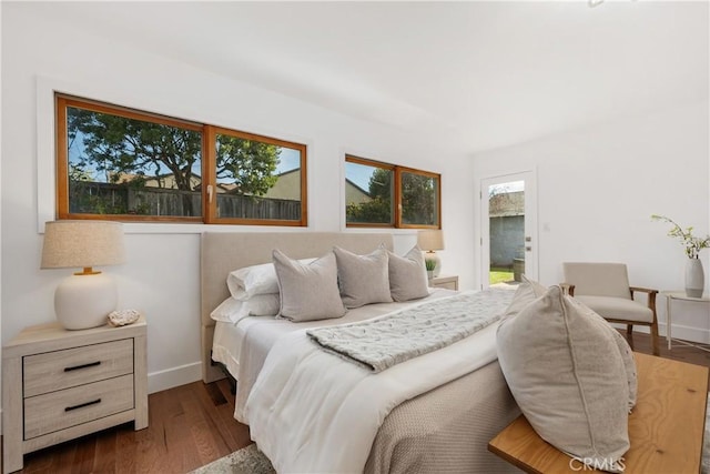 bedroom featuring baseboards and dark wood-style flooring