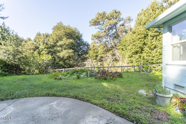 view of yard featuring a patio and fence