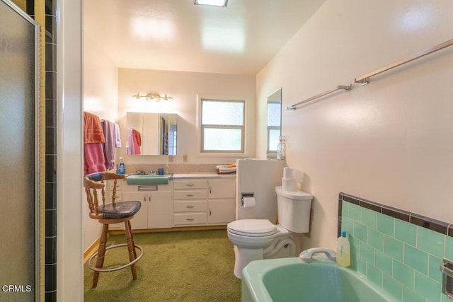 bathroom with a shower with door, a tub, toilet, and vanity