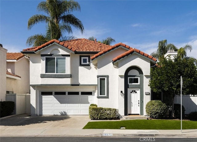 mediterranean / spanish-style home featuring stucco siding, a garage, driveway, and a tiled roof