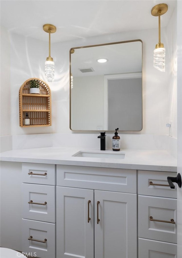 bathroom featuring visible vents, recessed lighting, and vanity