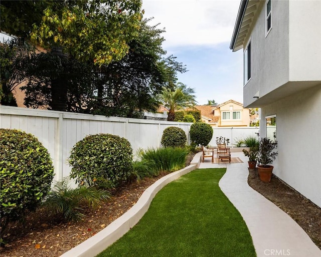 view of yard with a patio and a fenced backyard