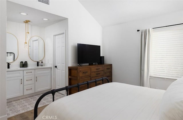 bedroom with recessed lighting, visible vents, lofted ceiling, and wood finished floors