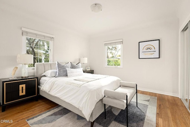 bedroom with baseboards and wood finished floors