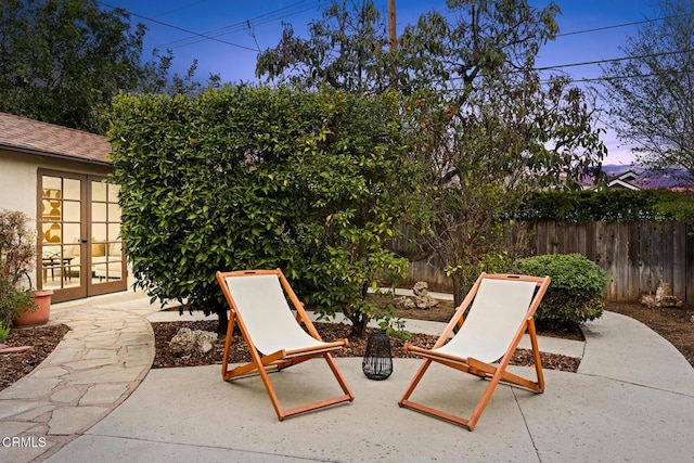 view of patio with french doors and a fenced backyard