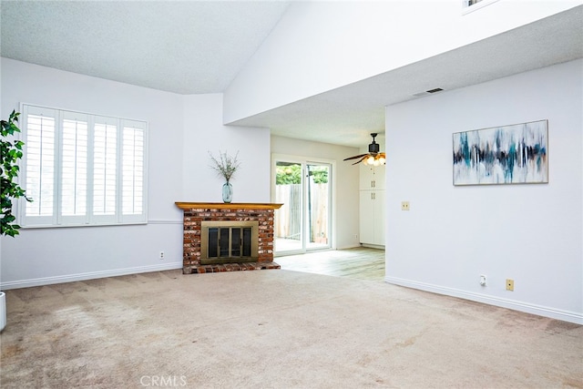 unfurnished living room featuring a ceiling fan, carpet, baseboards, a brick fireplace, and vaulted ceiling