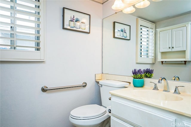 bathroom featuring toilet and vanity