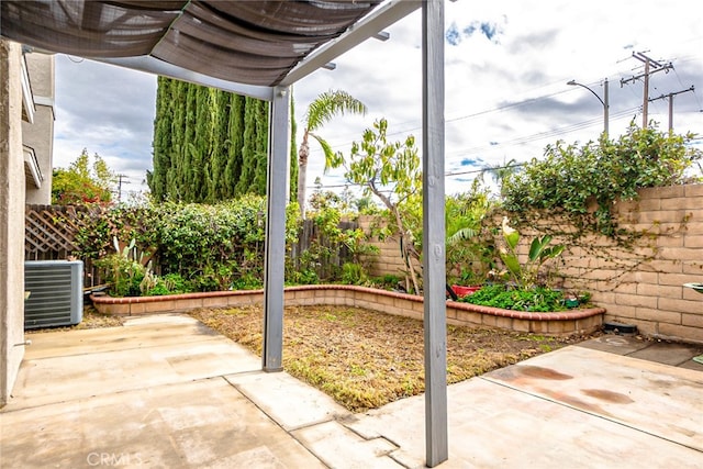 view of patio with a fenced backyard and central AC