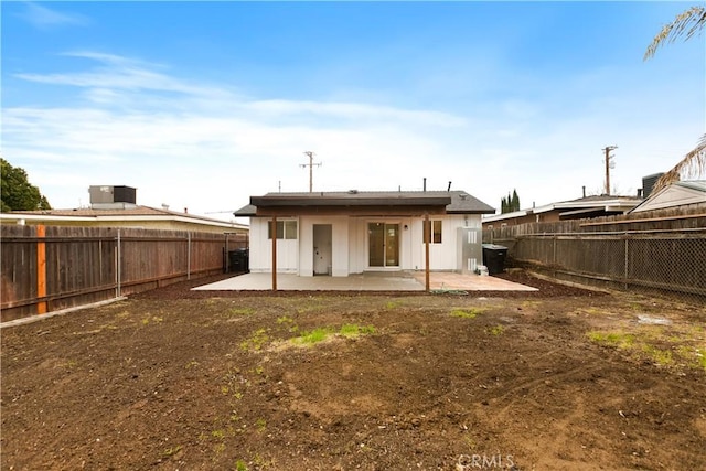 rear view of property with a patio and a fenced backyard