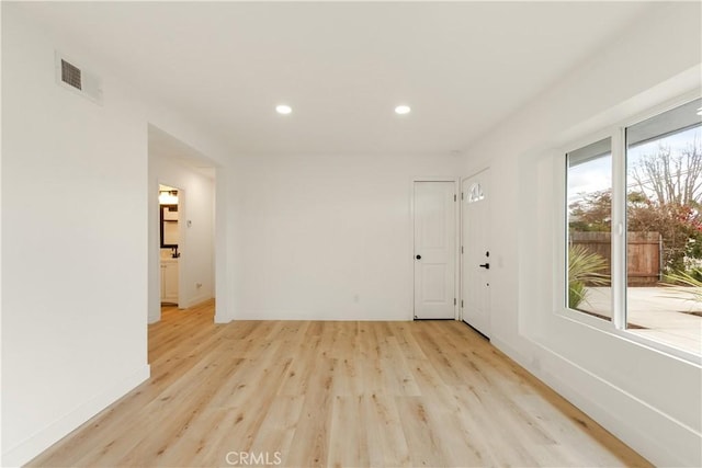 spare room featuring recessed lighting, visible vents, baseboards, and light wood finished floors