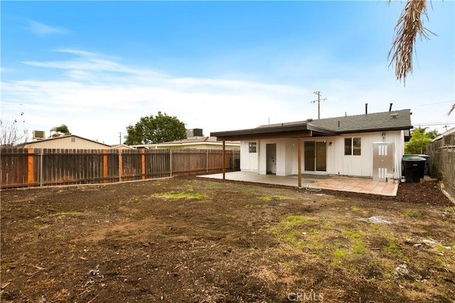 back of property with a patio and a fenced backyard