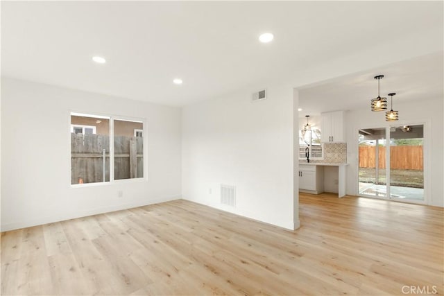 spare room featuring recessed lighting, visible vents, and light wood finished floors