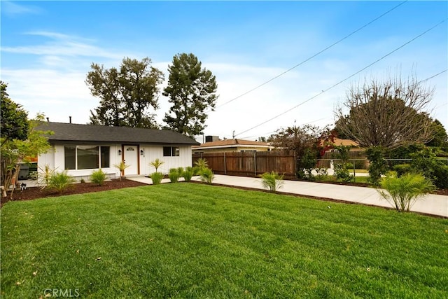 single story home with a front yard and fence