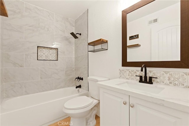 bathroom featuring visible vents, toilet, bathtub / shower combination, and vanity