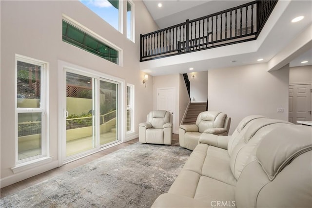 living room featuring stairs, recessed lighting, and wood finished floors