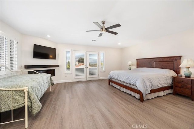 bedroom with access to exterior, recessed lighting, baseboards, and light wood-type flooring