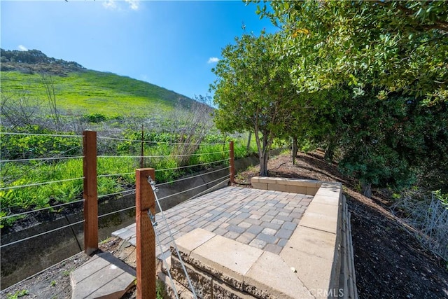 exterior space with a mountain view and fence