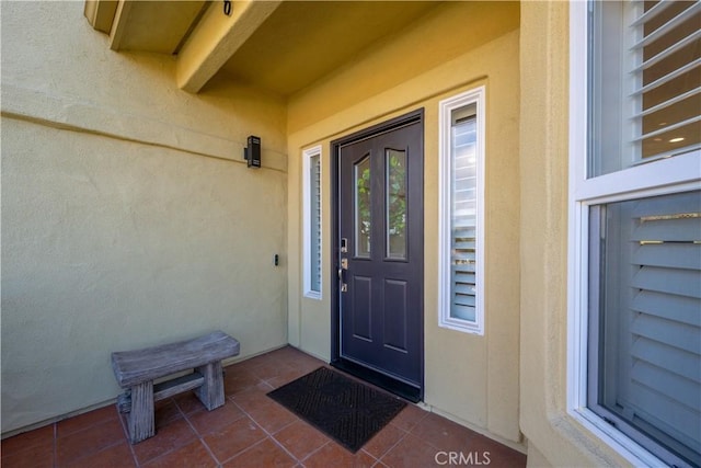 property entrance with stucco siding