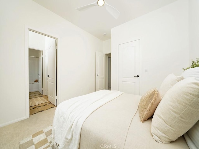 bedroom with a ceiling fan, carpet, baseboards, and connected bathroom