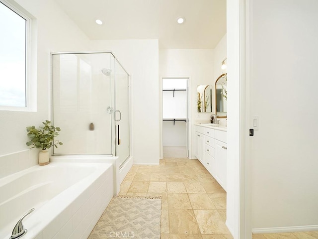 bathroom featuring vanity, a bath, recessed lighting, and a stall shower